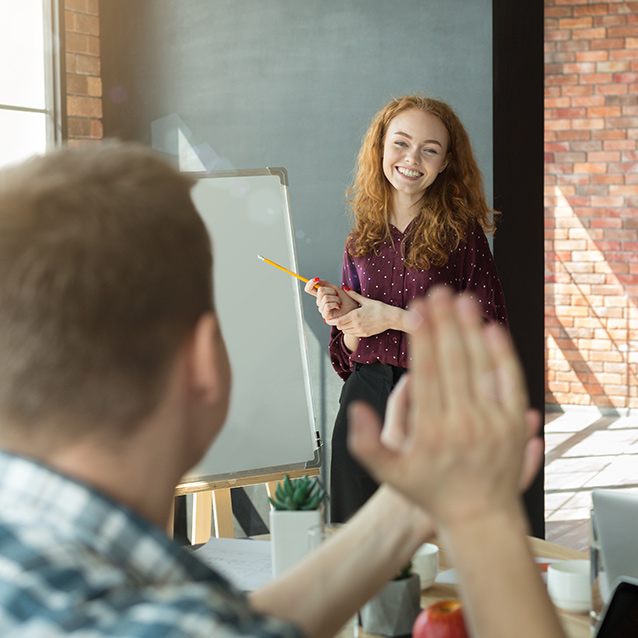 Marketing manager presenting strategy pointing on flip chart