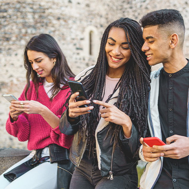 Gen Z friends using smartphones and social networks together